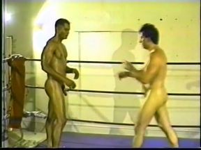 Black and white wrestlers fight naked on the stage