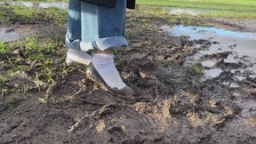 Amelie get her ballet flats and white socks muddy in a field