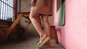 Sandals dangle from the feet of a beautiful cross-legged lady (7)