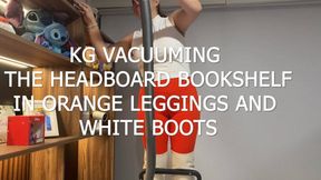 KG VACUUMING THE HEADBOARD BOOKSHELF IN ORANGE LEGGINGS AND WHITE BOOTS
