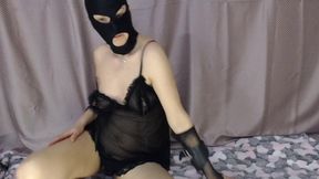 BDSM in a black mask and a leash around her neck, obedient whore