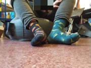 Twink boy feet in different colored socks in school