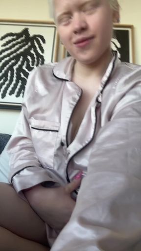 Curvy albino babe reveals her big tits while sitting
