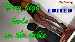 Black suede opentoe ultra high heels cock trampling on table. edited version