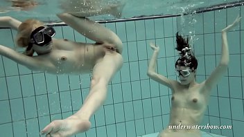 Girls swimming underwater and enjoying eachother