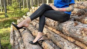 Black classic Stiletto High Heels with no back, 12 cm heels in the forest, deep in the sand