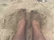 rubbing my feet in the sand on the beach