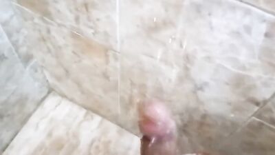 muscled man jerks off under the shower water, shows and massages his huge, hard cock until cumming, his milk is delicius