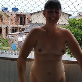 Wife works nude on balcony teasing her cuckold husband