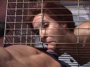 Submissive slut blowing police officers dick while in cage