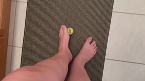 Size 12 feet, long toes picking up a small tennis item, Foot fetish
