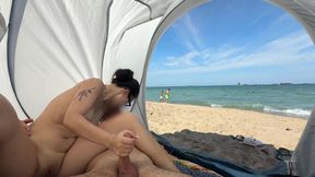 My Asian GF sits on a public beach, jerking my dick while I'm naked.
