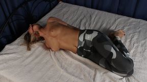 Ring-gagged topless barefoot Maggie in sport pants, hogtied with her elbows tied, wiggles and rolls on the bed (HD MOV)