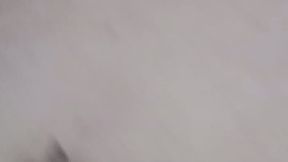 On the couch naked playing with a fake piercing