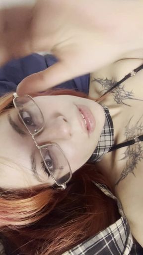 Red-haired woman in glasses lying down