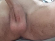 Skinny boy shaves his pubic hair on his dick while sitting on the floor