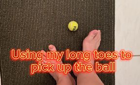 Size 12 feet, long toes picking up a small tennis ball, Foot fetish