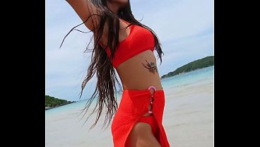 Orange bikini fun and beauty flashing on the beach