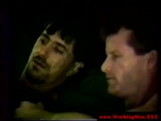 Two straight working men put condoms on