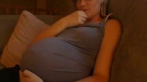 Short haired nerdy preggo pleased herself on the sofa