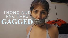 Gagged with a bikini thong and a strip of pvc tape
