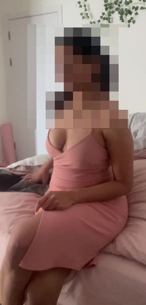 Curvy blonde Indian woman performs a striptease while sitting