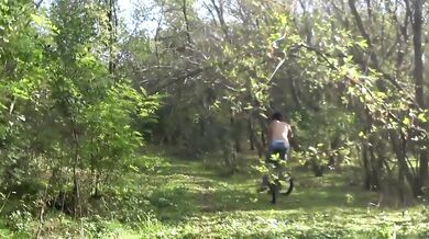 Topless MILF flashing her handyman on a bike in the forest