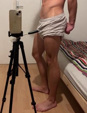 Young bodybuilder showing off his muscles in boxer shorts
