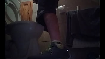 Sporty guy peeing at home