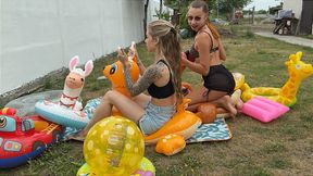 Nastya and Chloe blowing many inflatables outdoors