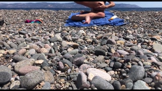 Girl going naked sunbathing at the nude beach