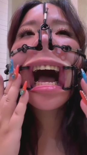Solo Asian woman teases her nose playfully