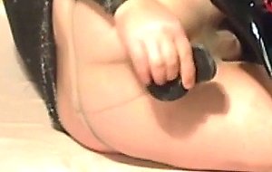Crossdresser inserts vibrator in asshole with pantyhose