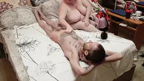 Mother-in-law massages his cock and balls, giving attention to his manhood.
