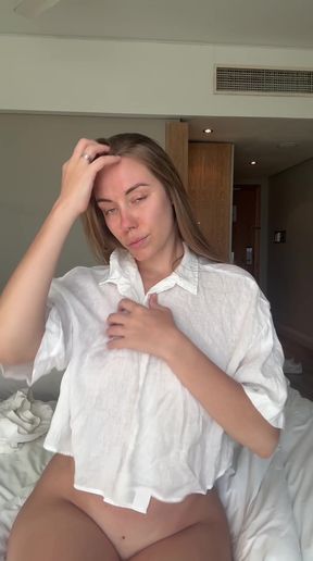 Woman in white shirt scratching head