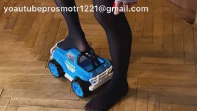 Nastya in black tights tramples a toy car, steps on it, crushes it with her weight, and breaks it. The car is unlucky. crush fetish and foot fetish and domination