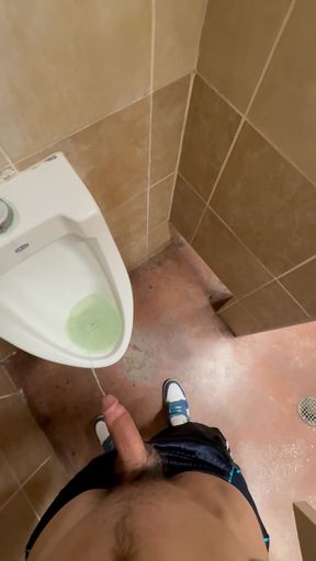 Athletic twink pees on his penis in public