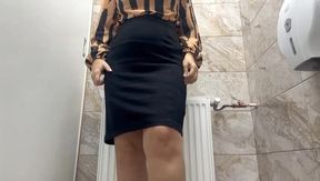 Horny wife in short skirt takes off her panties and starts rubbing her pussy in a public bathroom