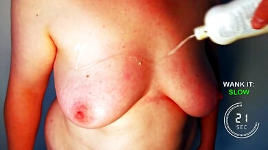 Topless figure explores their body under warm orange light