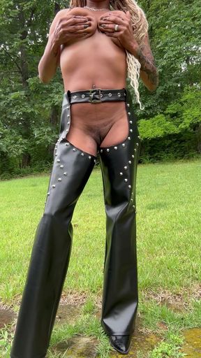 Woman in chaps teases with a smile