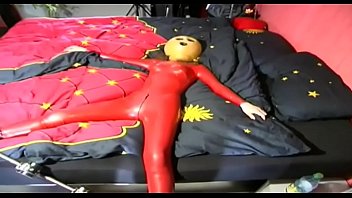 Fetish depravation for a red latex dressed slave