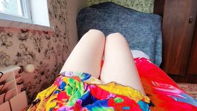 Sweet femboy leaning on balcony railing at sunset