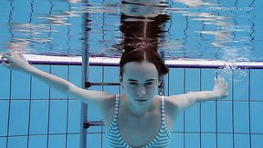 Slim redhead sweetie Anna Netrebko swims naked under water