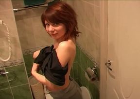 Redhead marvelous cutie in the toilet room undresses and pisses on cam