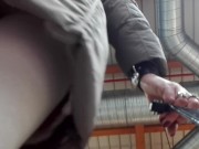 Sissy in white pantyhose and chastity cage underskirt and pissing at market