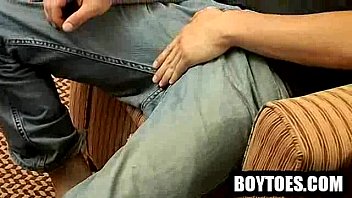 Amateur stud rubbing his feet before tugging his cock