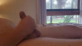 Thick husband strokes himself by the open window