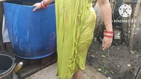 Indian housewife bathing outside with dance