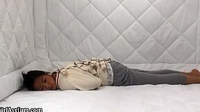 Asian woman in a straitjacket and padded cell