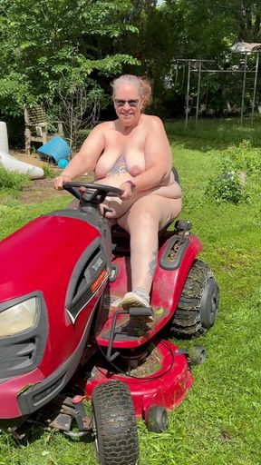 Naked woman mows lawn while cameraman dodges danger